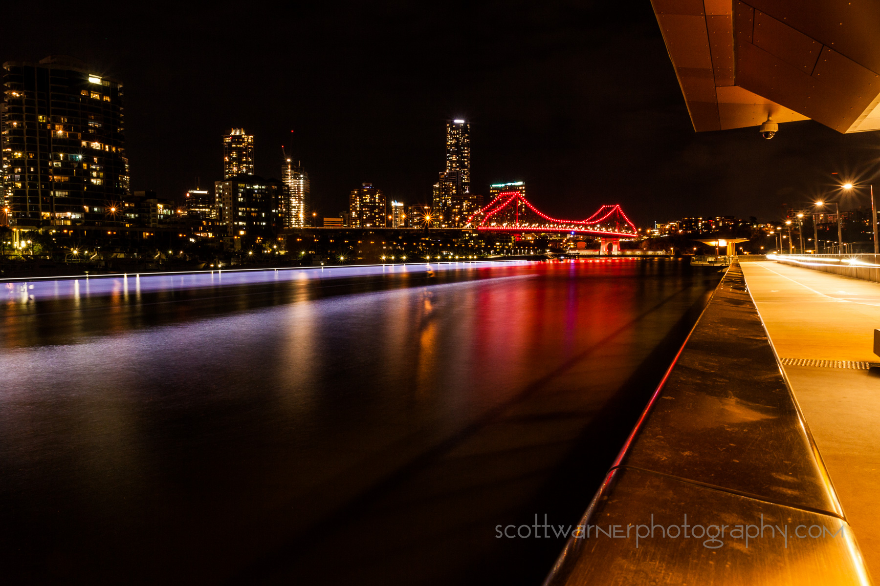 From the Riverside boardwalk as the Citycat Ferry and a cyclist go past